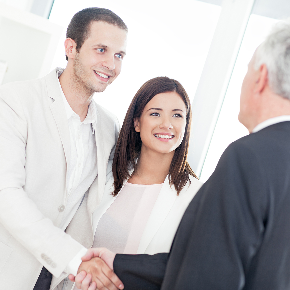 Lawyer Clayton MO, man in suit with young couple, shaking man's hand. Jeff Paul Paul Jeff Paul Jeffrey Paull Jeff